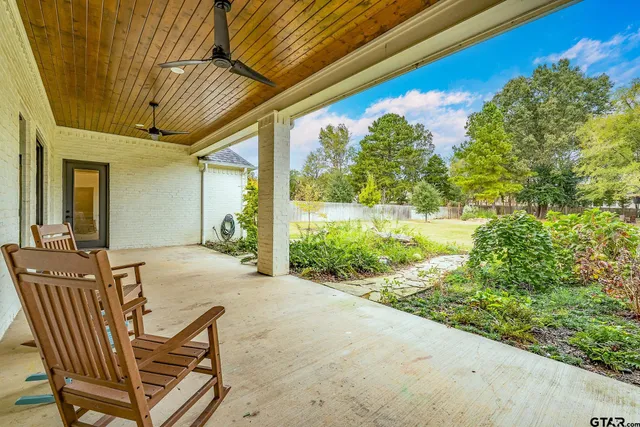 a view of a patio with table and chairs and potted plants