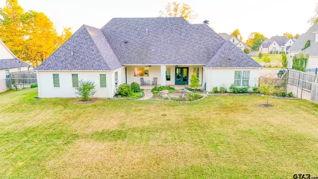 a front view of house with yard and trees