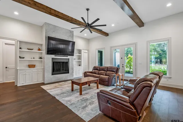 a living room with furniture a fireplace and a flat screen tv