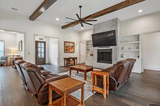 a living room with furniture a flat screen tv and a fireplace