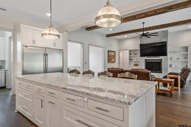 a view of living room kitchen island furniture and fireplace