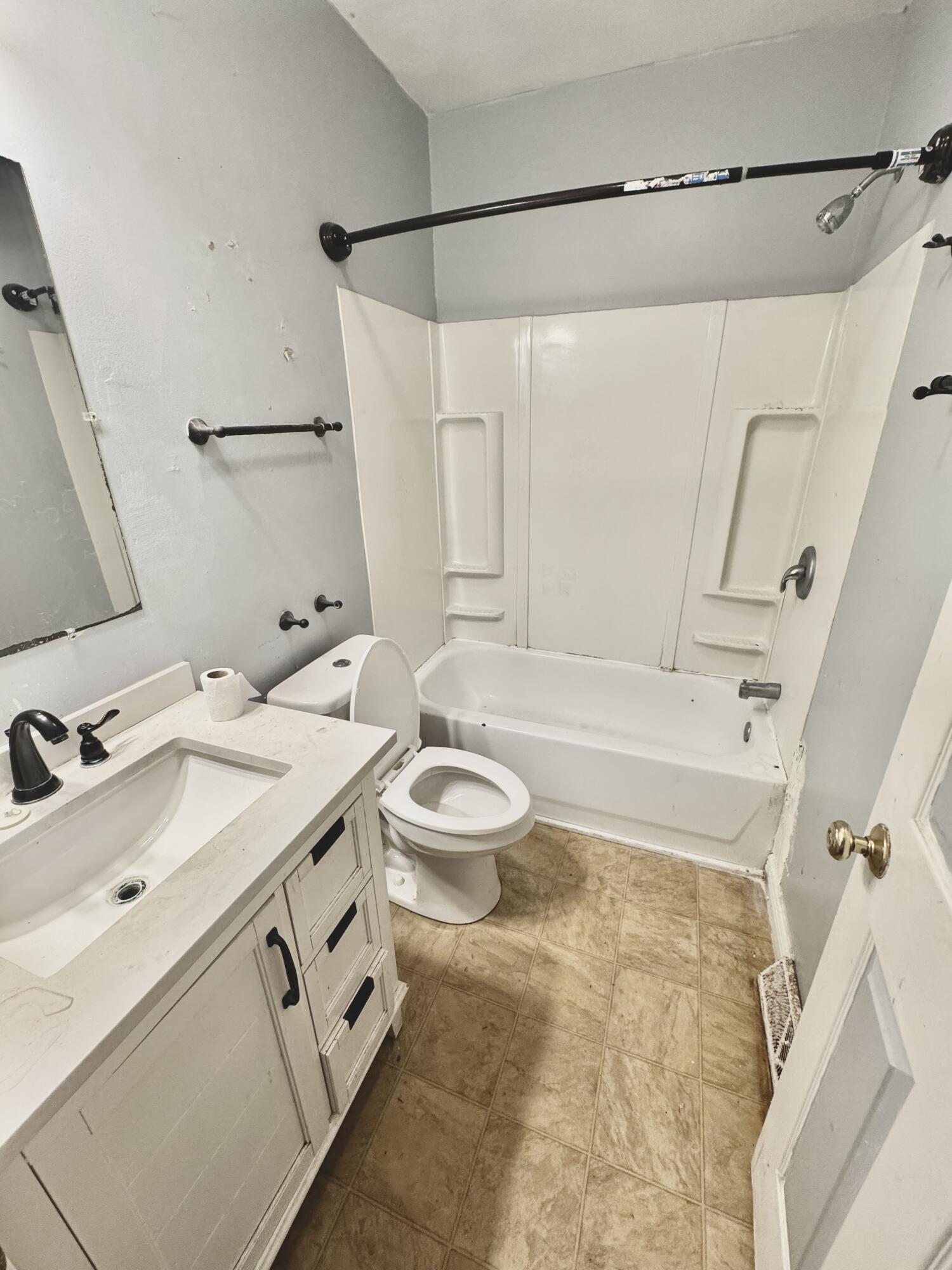 809 Chicago Street La Porte, IN 46350 - Photo 8 of 11 a bathroom with a granite countertop sink a toilet and shower