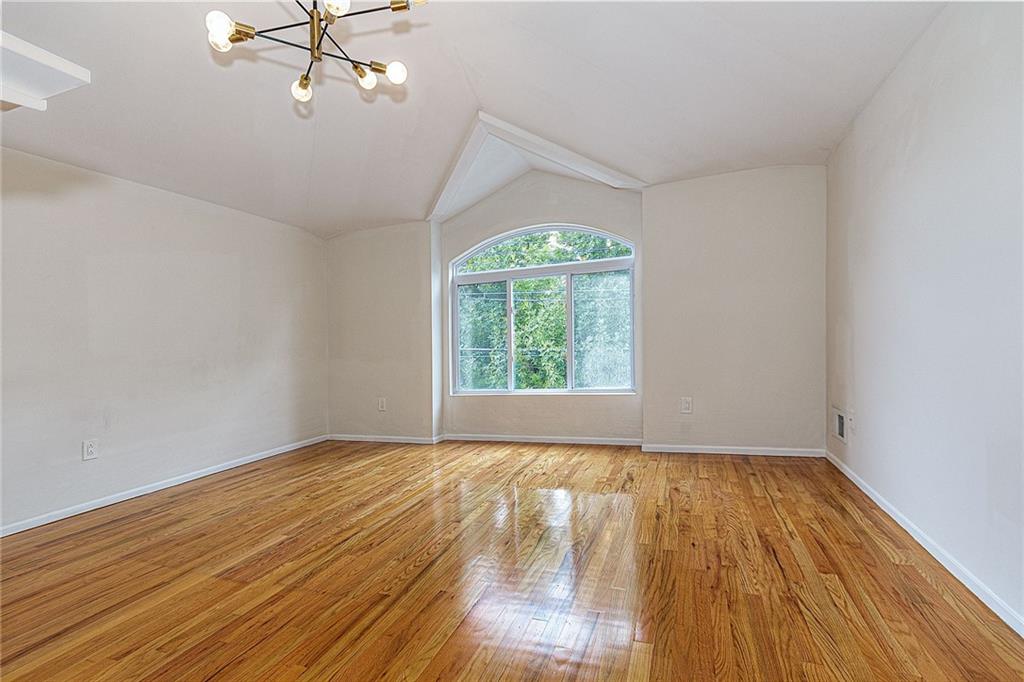 6652 Ave. M Brooklyn, NY 11234 - Photo 12 of 18 a view of an empty room with a window and wooden floor