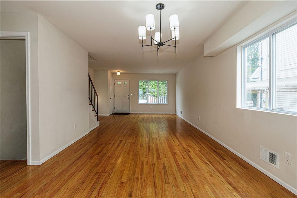 6652 Ave. M Brooklyn, NY 11234 - Photo 3 of 18 a view of empty room with wooden floor and fan