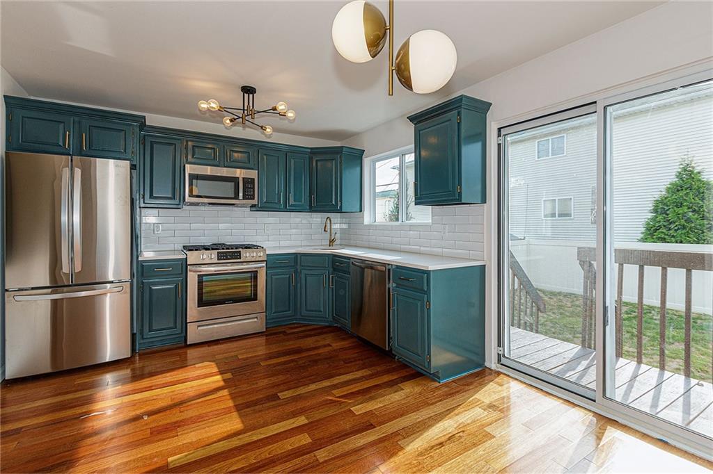 6652 Ave. M Brooklyn, NY 11234 - Photo 4 of 18 a kitchen with kitchen island granite countertop a stove a sink and a refrigerator