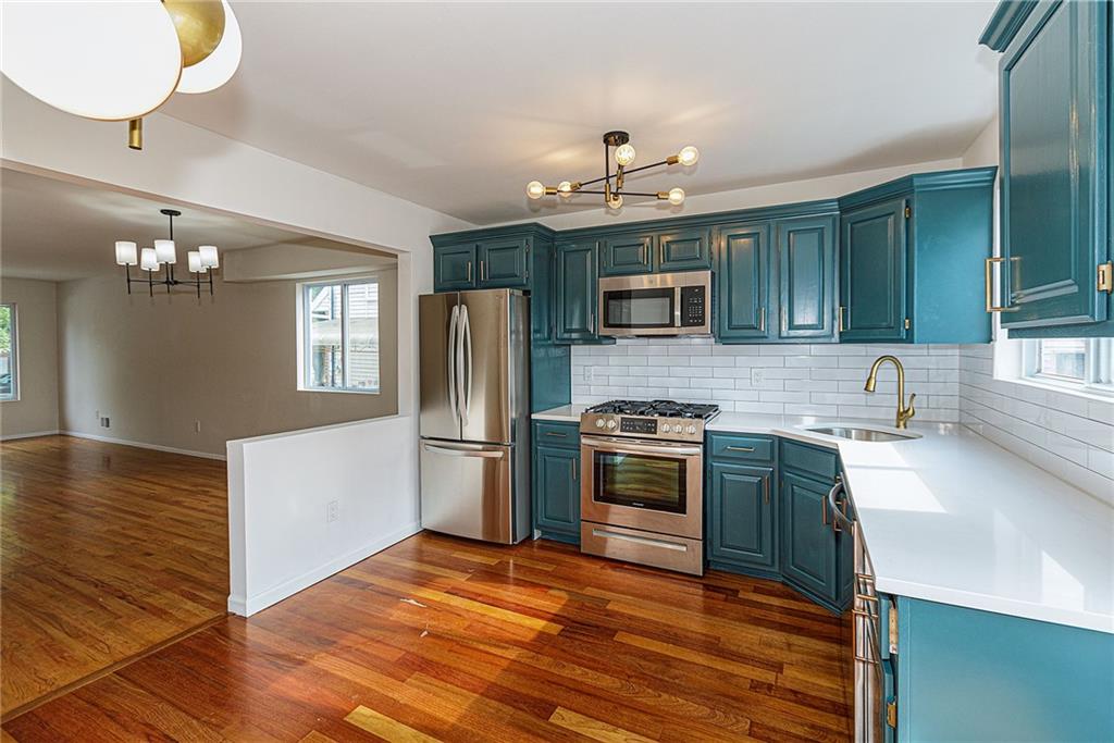 6652 Ave. M Brooklyn, NY 11234 - Photo 5 of 18 a kitchen with kitchen island granite countertop stainless steel appliances cabinets a sink and a counter top space