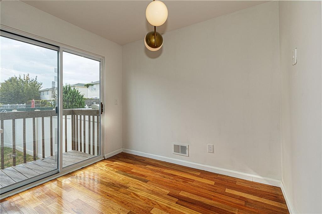 6652 Ave. M Brooklyn, NY 11234 - Photo 6 of 18 a view of a room with wooden floor and windows