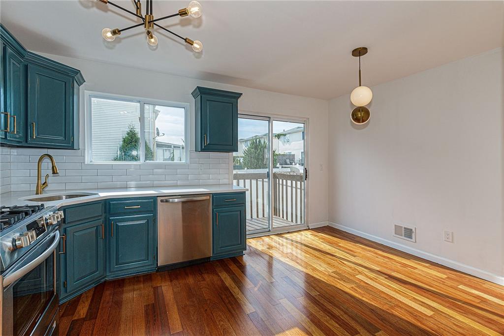 6652 Ave. M Brooklyn, NY 11234 - Photo 7 of 18 a kitchen with wooden floors and window