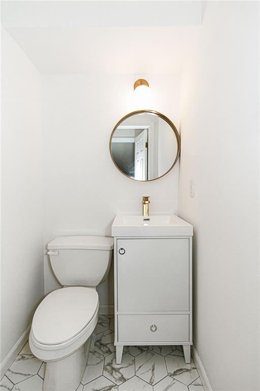 6652 Ave. M Brooklyn, NY 11234 - Photo 8 of 18 a bathroom with a toilet sink and mirror
