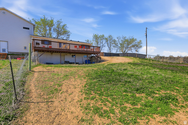 830 North Stone Road Snowville, UT 84336 - Photo 39 of 69 Rear view of house featuring a fenced backyard and a wooden deck