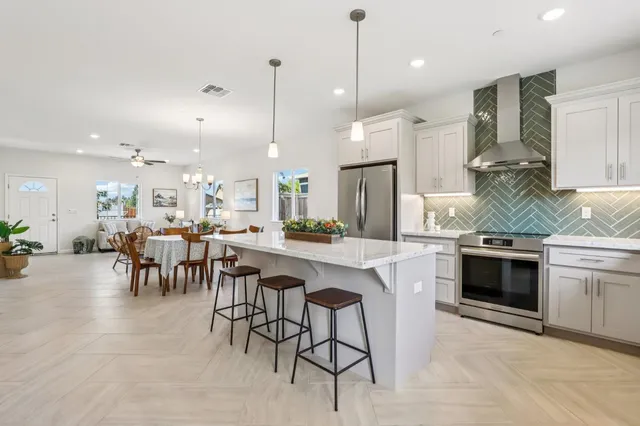 a large kitchen with a table and chairs