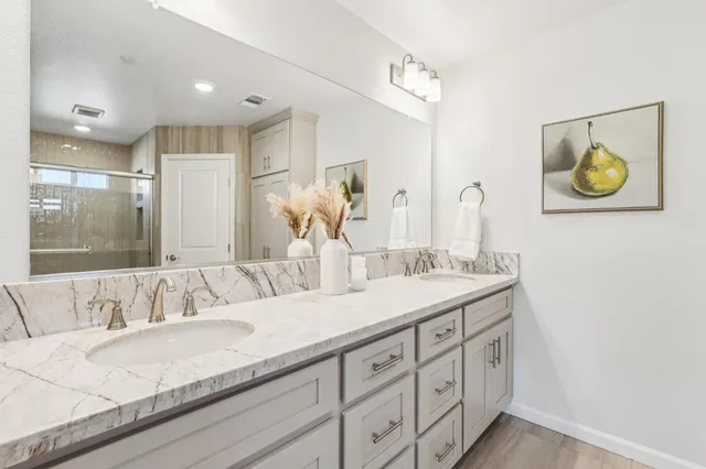a en suite bathroom with double sink and a mirror