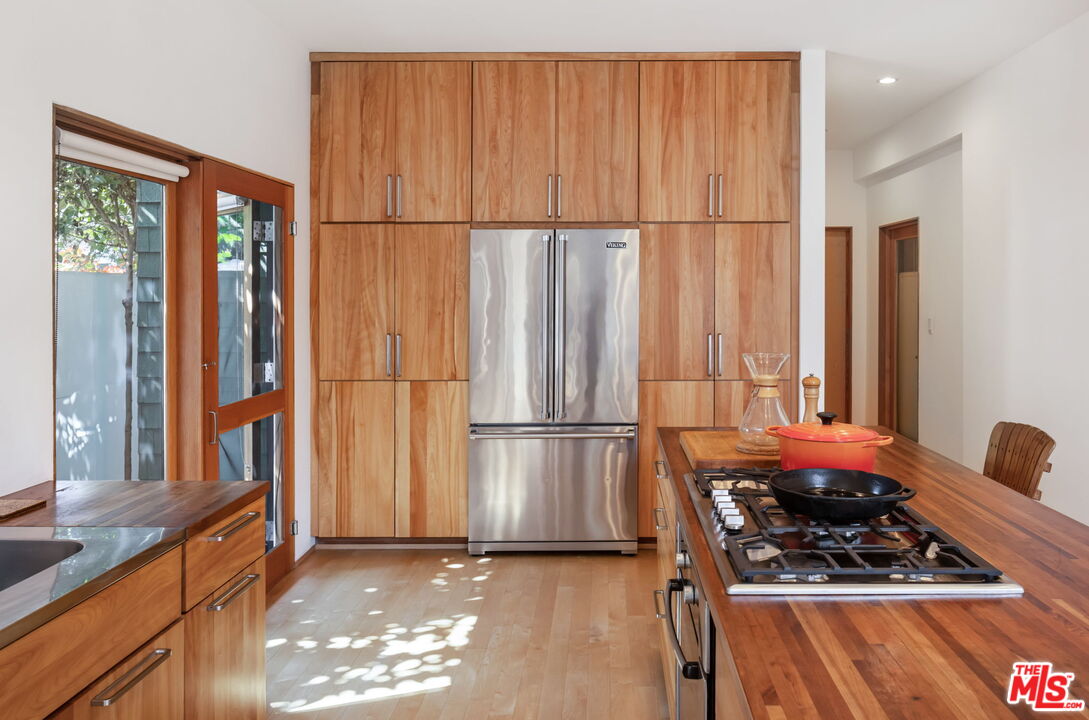 341 5th Avenue Venice, CA 90291 - Photo 3 of 24 a kitchen with stainless steel appliances granite countertop a refrigerator and a stove top oven