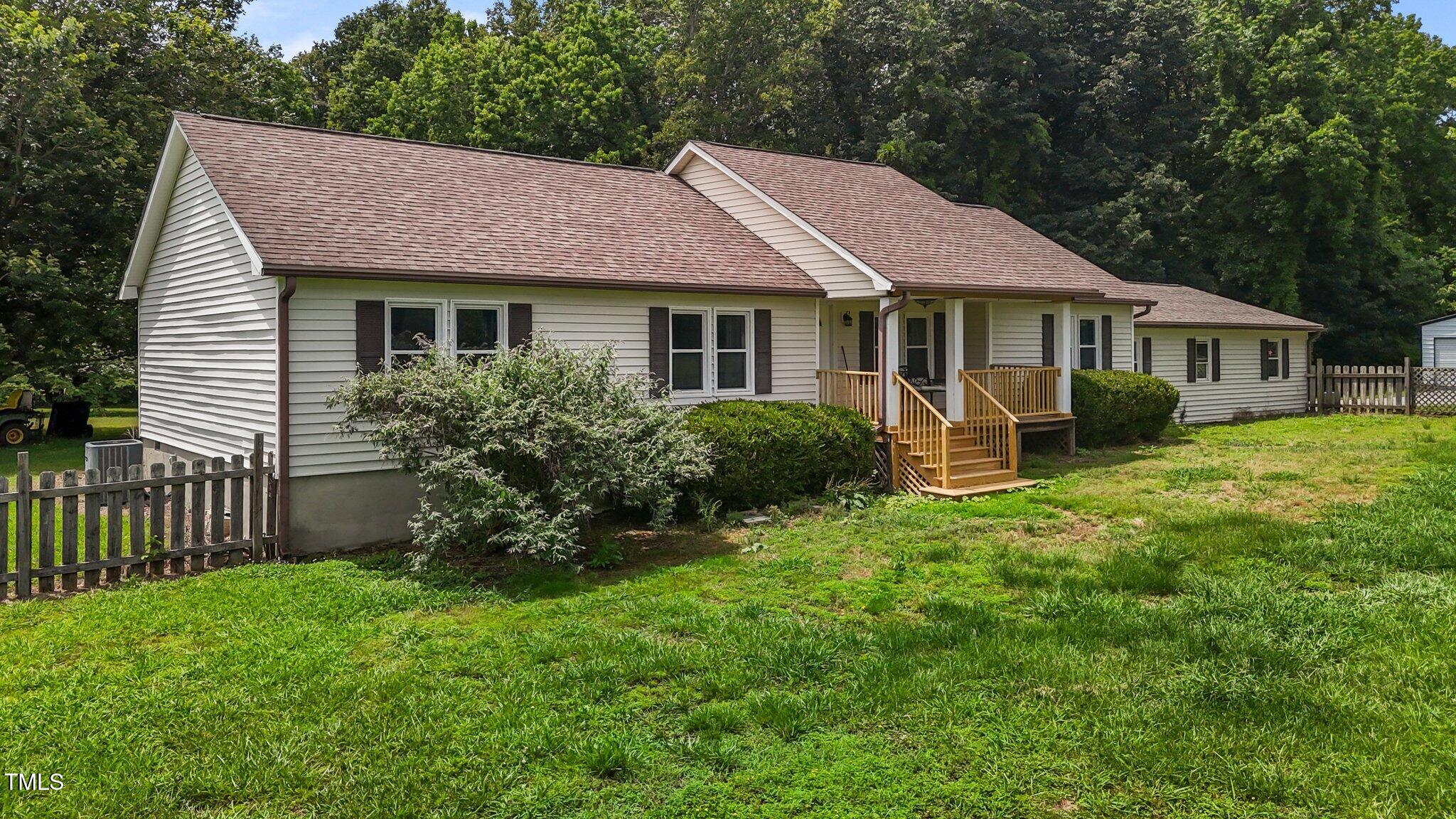 1167 John D Winstead Road Roxboro, NC 27574 - Photo 3 of 55 a front view of a house with garden