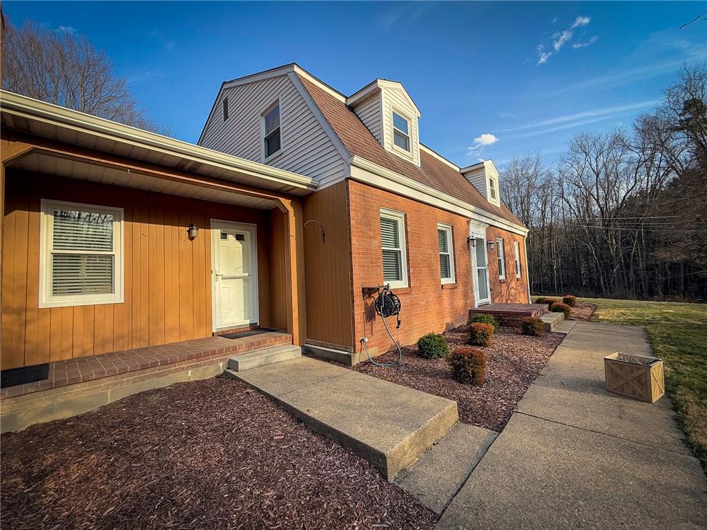 163 Crisswell Road Butler, PA 16002 - Photo 2 of 46 a view of a house with couches chairs and wooden floor