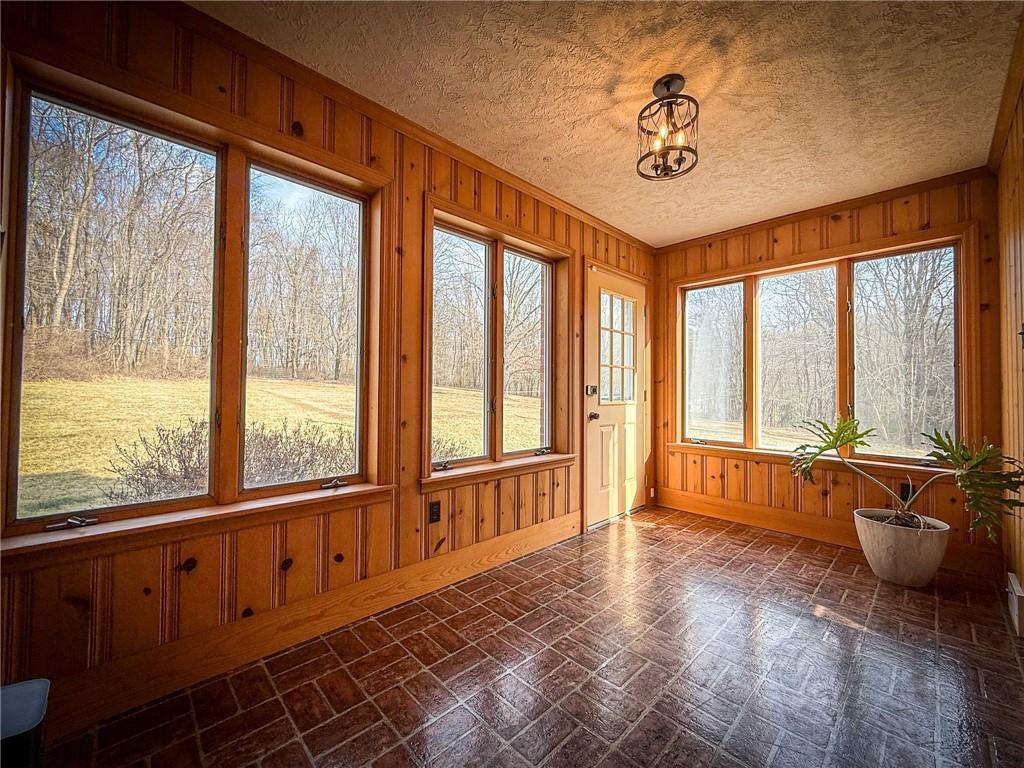 163 Crisswell Road Butler, PA 16002 - Photo 22 of 46 a living room with furniture and floor to ceiling windows