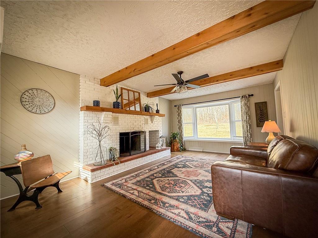 163 Crisswell Road Butler, PA 16002 - Photo 3 of 46 a living room with furniture and a fireplace