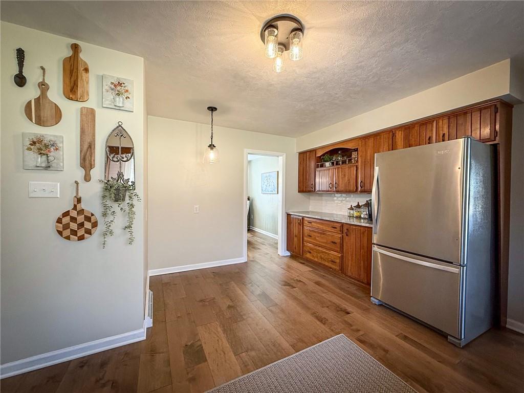 163 Crisswell Road Butler, PA 16002 - Photo 9 of 46 a kitchen with stainless steel appliances a refrigerator and wooden floor
