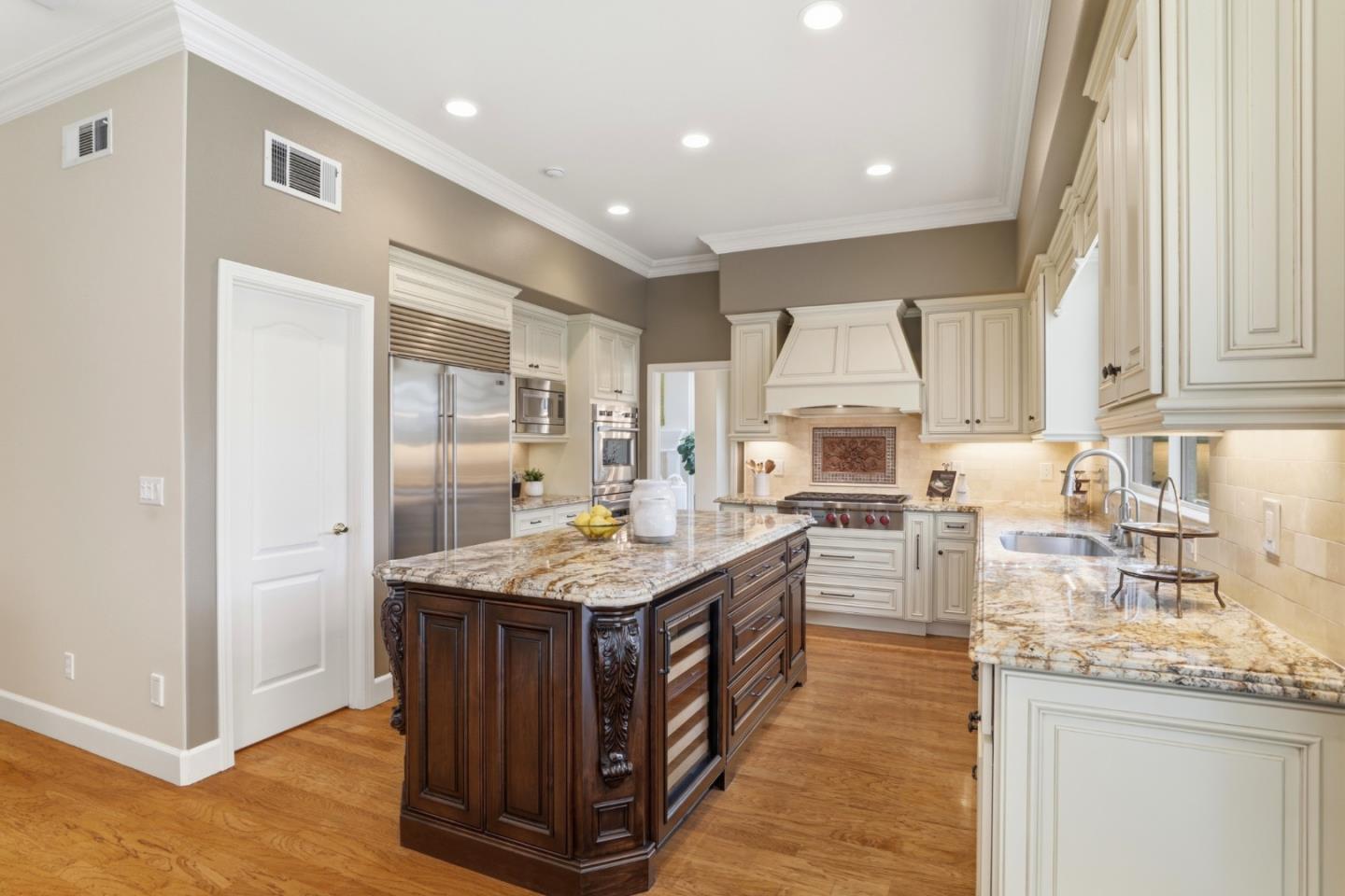 1134 Falcon Ridge Court San Jose, CA 95120 - Photo 12 of 63 a kitchen with stainless steel appliances granite countertop a stove a sink dishwasher and a refrigerator with wooden floor