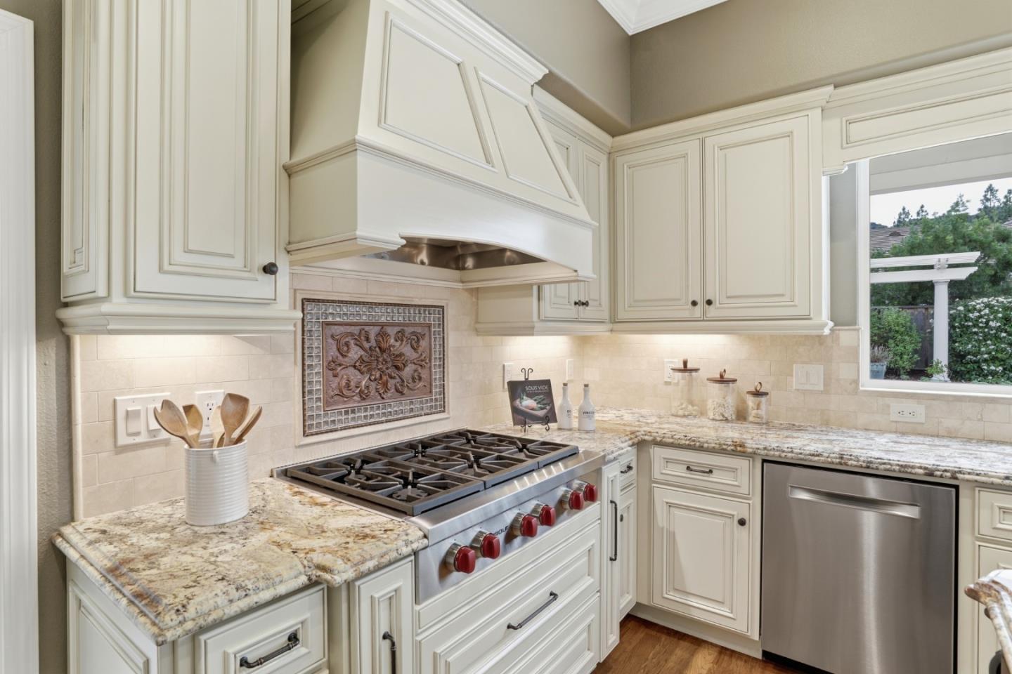 1134 Falcon Ridge Court San Jose, CA 95120 - Photo 15 of 63 a kitchen with granite countertop a stove sink and cabinets