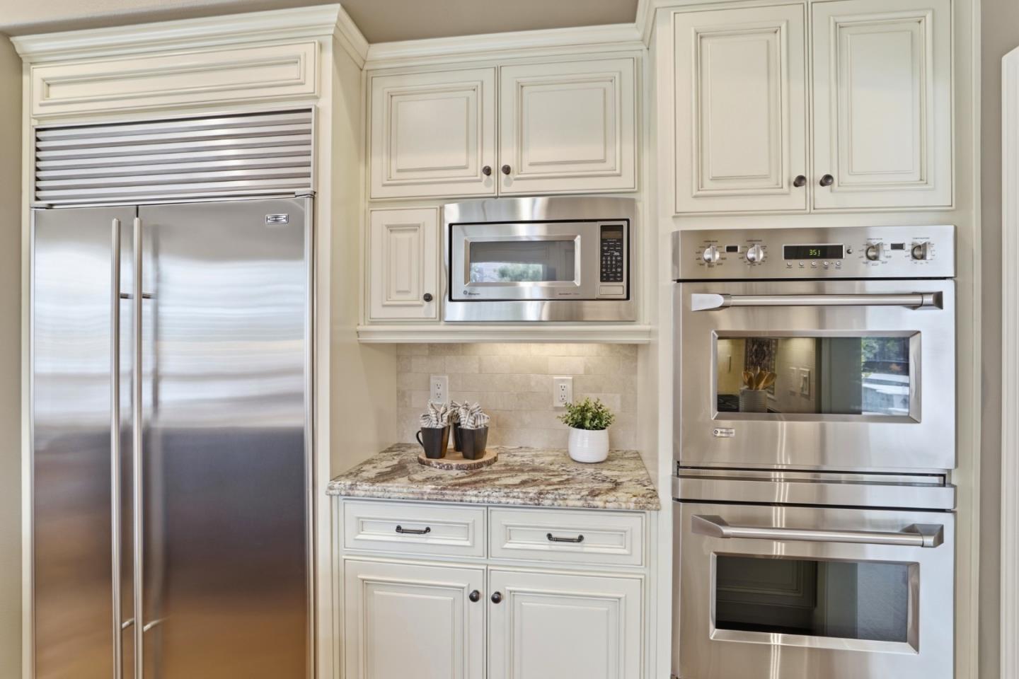 1134 Falcon Ridge Court San Jose, CA 95120 - Photo 16 of 63 a kitchen with granite countertop white cabinets and stainless steel appliances