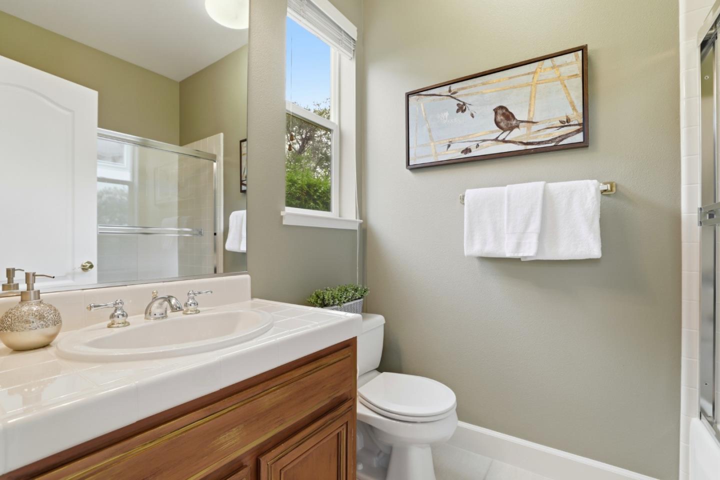 1134 Falcon Ridge Court San Jose, CA 95120 - Photo 35 of 63 a bathroom with a sink mirror and toilet