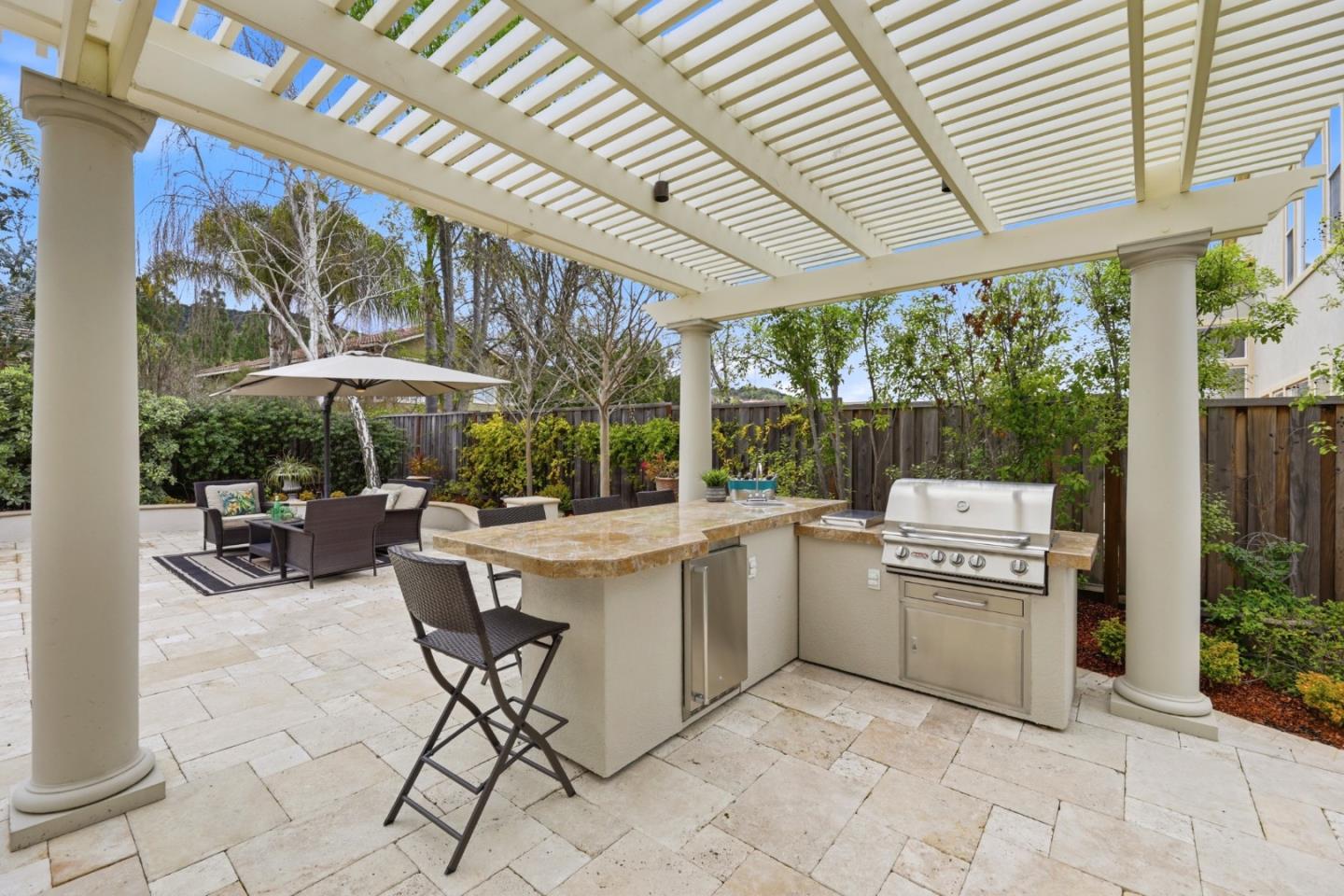 1134 Falcon Ridge Court San Jose, CA 95120 - Photo 43 of 63 a view of a patio with a table and chairs under an umbrella