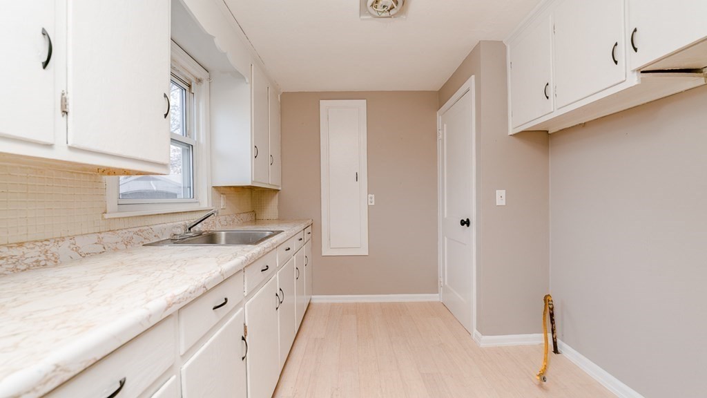 33 Bernard Street Springfield, MA 01109 - Photo 6 of 15 a bathroom with a granite countertop sink and a mirror