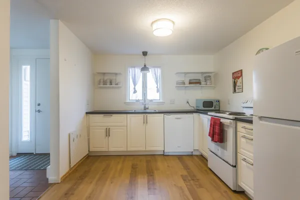 a kitchen with stainless steel appliances granite countertop a stove a sink and a refrigerator