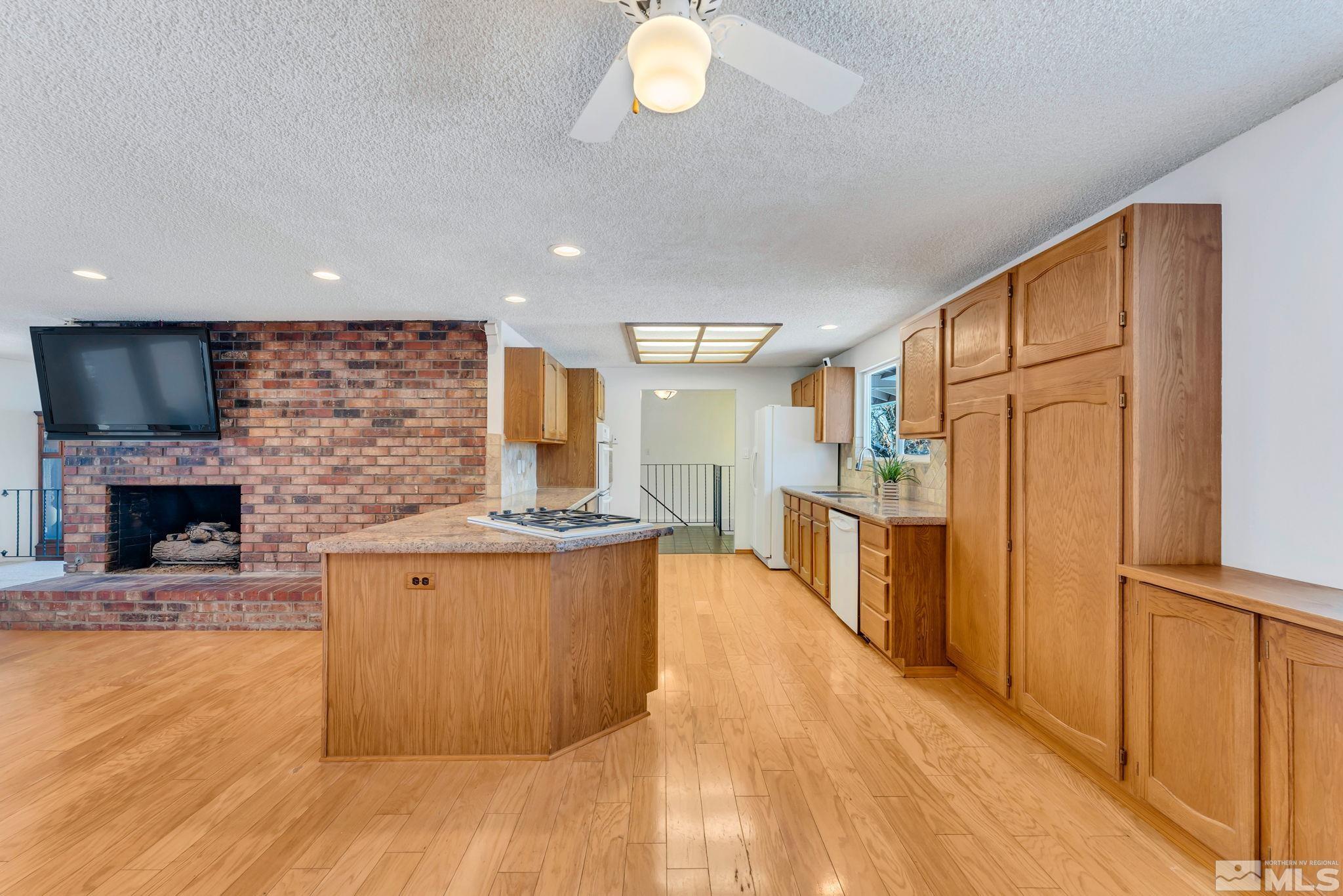 2047 Regent Street Reno, NV 89509 - Photo 7 of 28 a large kitchen with stainless steel appliances granite countertop a stove and a refrigerator