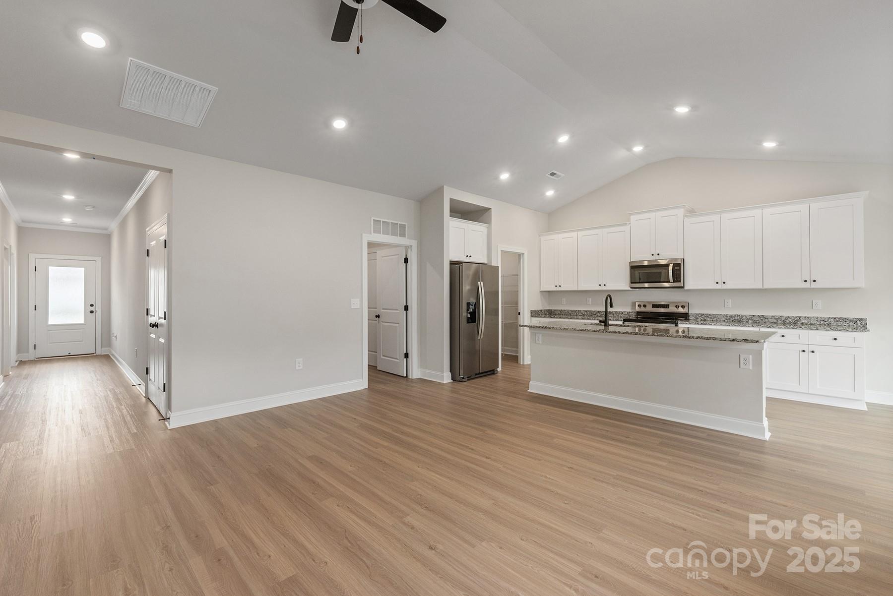 7015 Jerimoth Drive Charlotte, NC 28215 - Photo 3 of 9 a view of kitchen with stainless steel appliances refrigerator stove microwave and cabinets