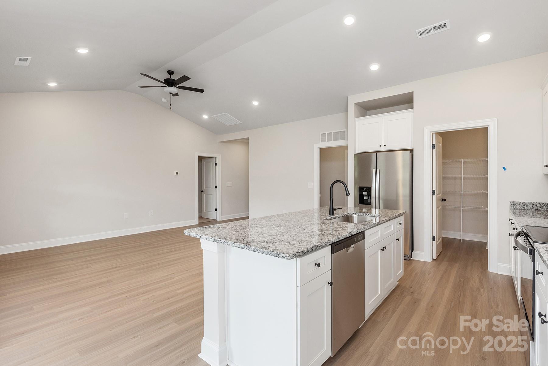 7015 Jerimoth Drive Charlotte, NC 28215 - Photo 6 of 9 a large kitchen with stainless steel appliances granite countertop a lot of counter space and wooden floors