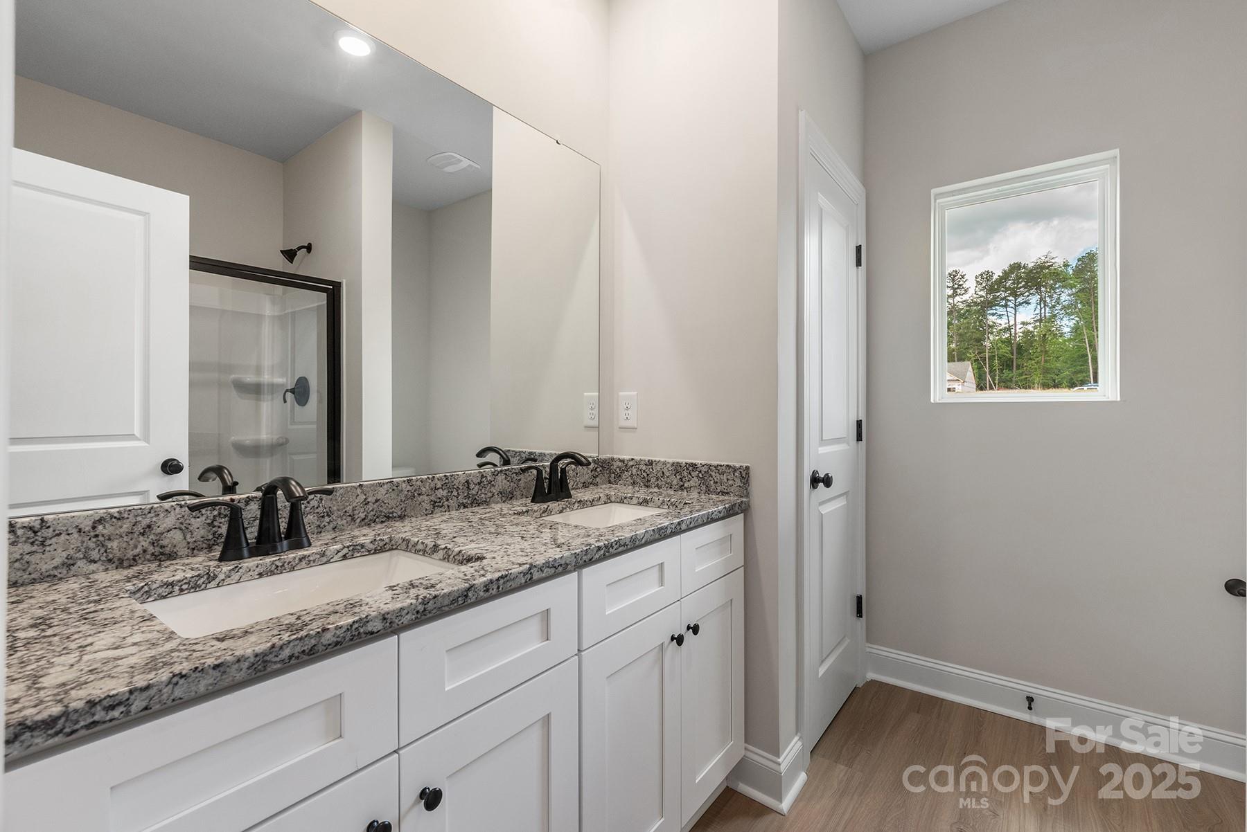 7015 Jerimoth Drive Charlotte, NC 28215 - Photo 9 of 9 a bathroom with a granite countertop sink and a mirror
