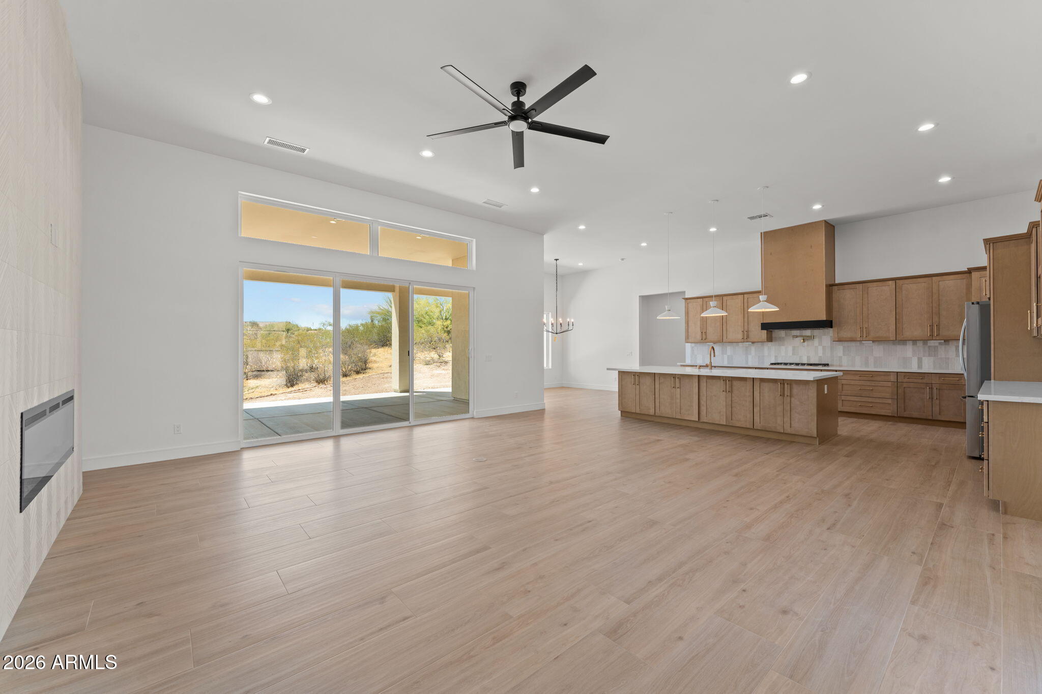 2855 Percheron Road Wickenburg, AZ 85390 - Photo 10 of 58 a large kitchen with stainless steel appliances granite countertop a stove a sink and a large refrigerator with wooden floor
