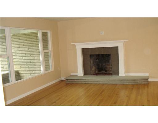 235 Stone Church Road Hunker, PA 15639 - Photo 2 of 10 Living Room. LIVINGROOM WITH LOADS OF WINDOWS, HARDWOOD FLOORS, AND FIREPLACE