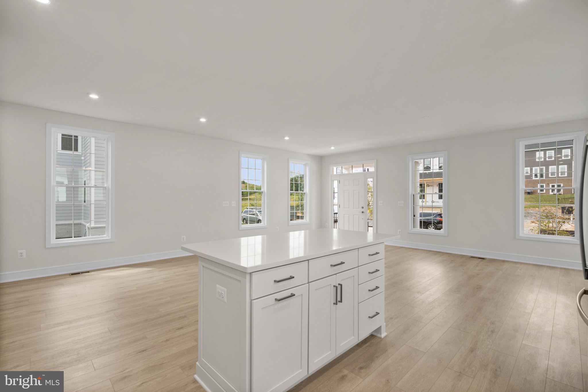 1013 Captain Richards Court Marshall, VA 20115 - Photo 12 of 44 a hall with kitchen island a sink wooden floor and a large window