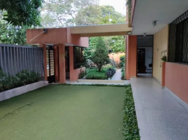 a view of a house with backyard and porch