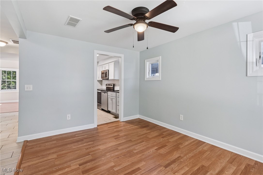159 Eastland Road Berea, OH 44017 - Photo 10 of 38 Empty room with light wood finished floors and ceiling fan