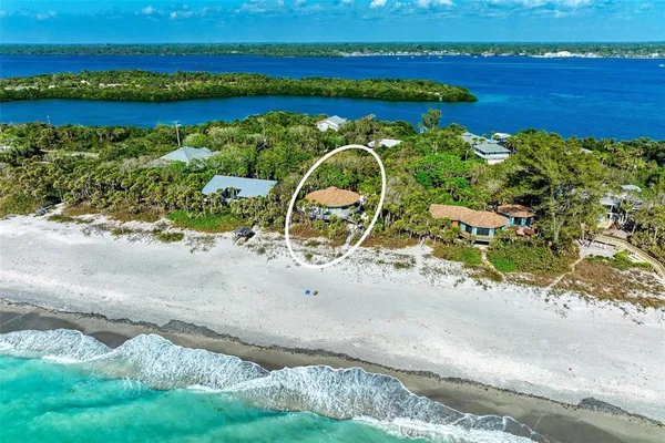 an aerial view of a houses with a yard and lake view