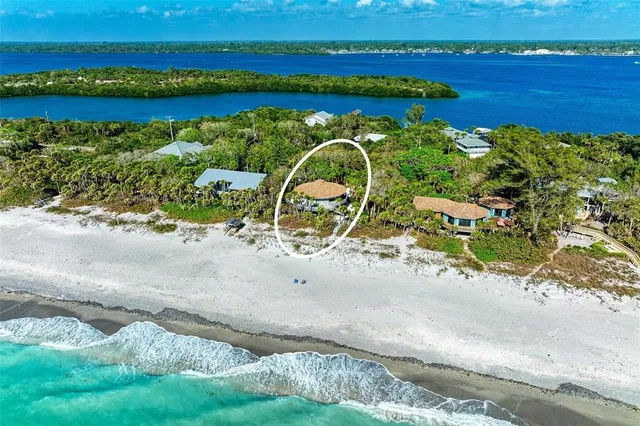 an aerial view of a houses with a yard and lake view