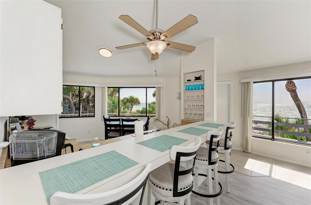 6590 Manasota Key Road Englewood, FL 34223 - Photo 17 of 69 a living room with furniture a large window with a table and chairs
