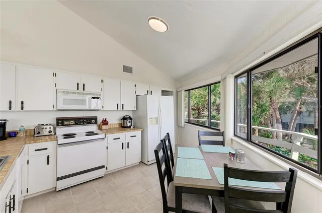 a kitchen with a sink cabinets and wooden floor