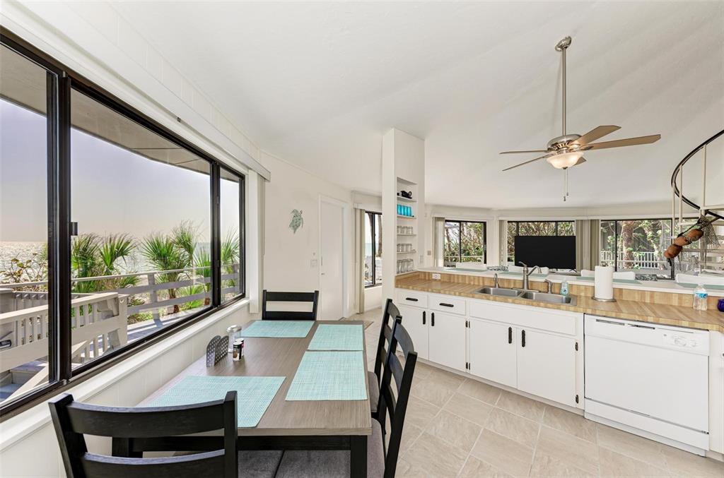 6590 Manasota Key Road Englewood, FL 34223 - Photo 21 of 69 a view of a dining room with furniture window and wooden floor