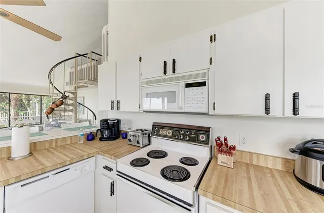 a large bedroom with a bed and a flat screen tv