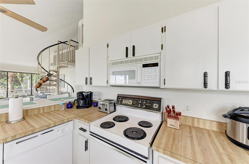 6590 Manasota Key Road Englewood, FL 34223 - Photo 22 of 69 a kitchen with appliances cabinets and a stove top oven