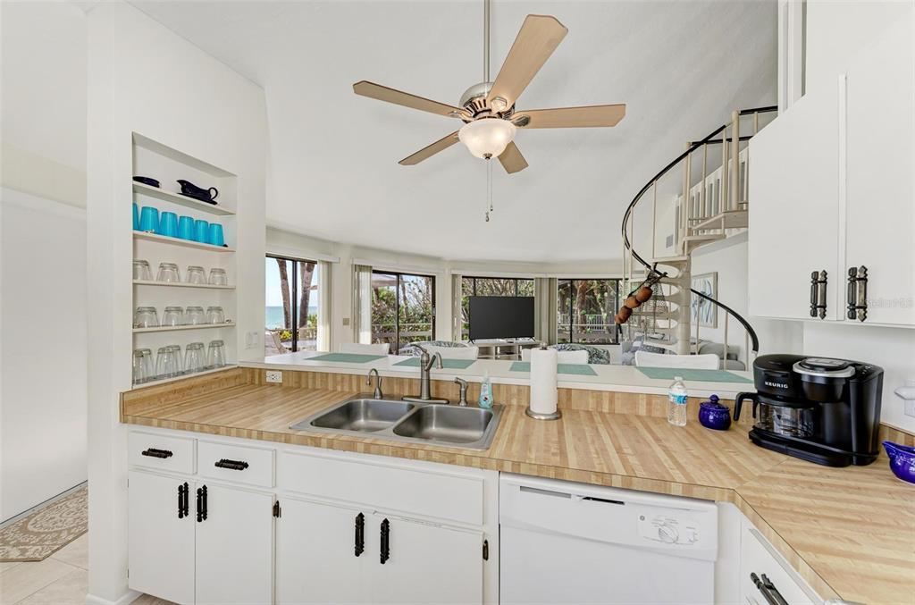 6590 Manasota Key Road Englewood, FL 34223 - Photo 23 of 69 a kitchen with a sink cabinets and wooden floor