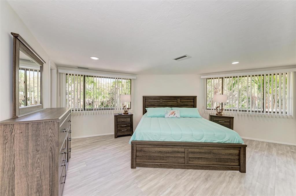 6590 Manasota Key Road Englewood, FL 34223 - Photo 25 of 69 a bedroom with a large bed and a large window