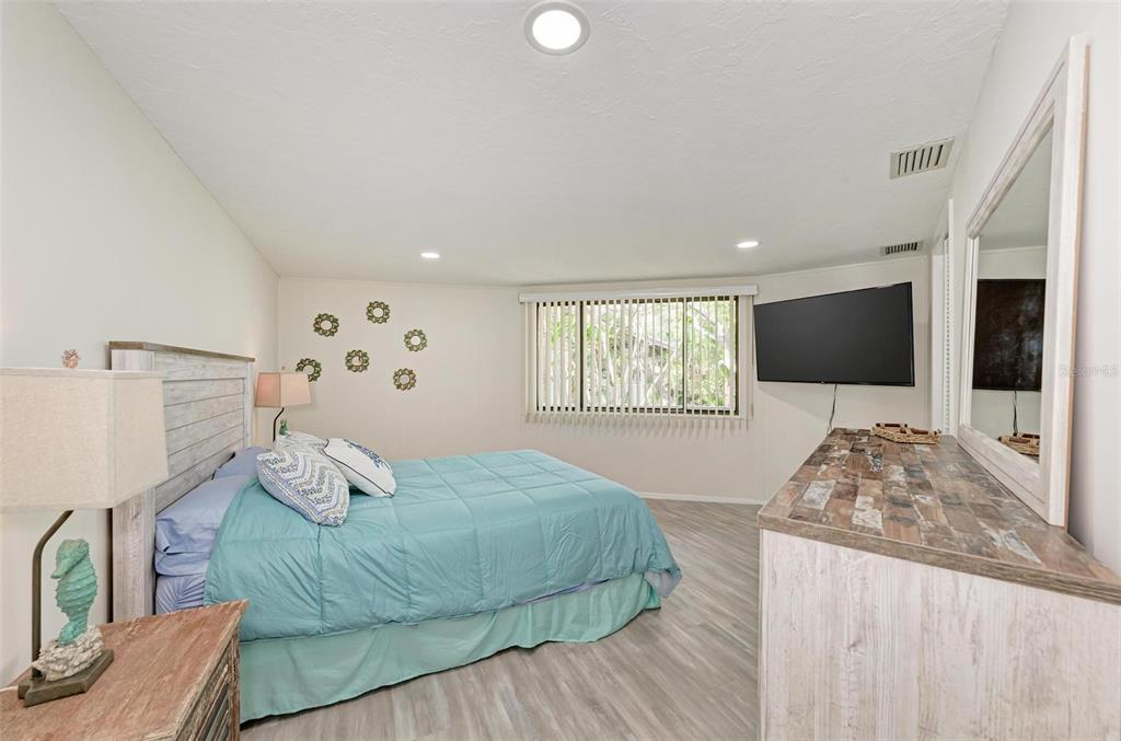 6590 Manasota Key Road Englewood, FL 34223 - Photo 33 of 69 a living room with a bed furniture and a flat screen tv