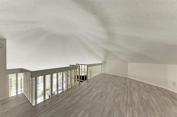 a view of a balcony with wooden floor