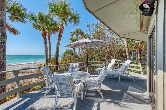 a outdoor space with the couches and dining table with the garden view
